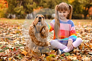 Cute little girl with her pet in park