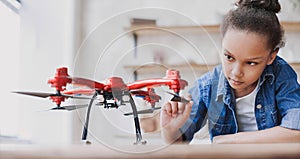 Cute little girl holding drone. Child playing with drone at home. Education, children, technology, science, future concept