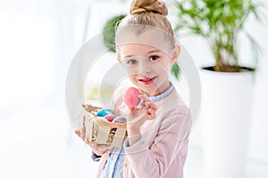 Cute little girl holding painted