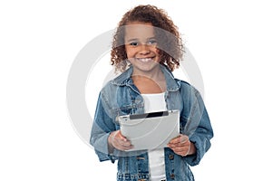 Cute little girl holding tablet pc