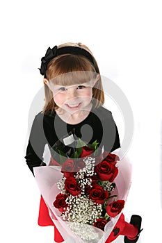 Cute little girl in holiday dress with red roses