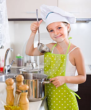 Cute little girl at home kitchen