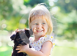 Cute little girl hugging dog puppy outdoors