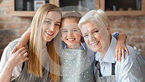 Cute little girl hugging her mom and granny