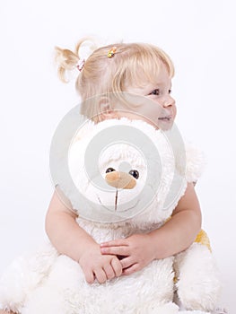 Cute little girl hugging teddybear photo