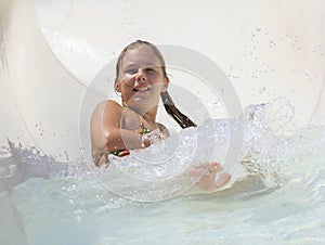 The cute little girl joying in water