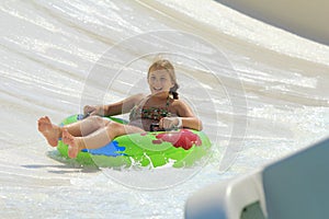 The cute little girl joying in the water park