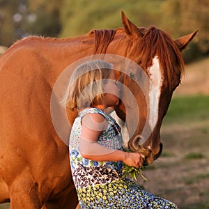 Cute little girl kissing her horse