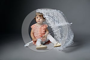 Cute little girl with lace umbrella