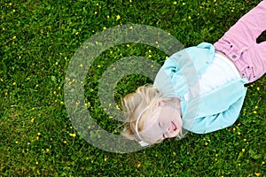 Cute little girl laying in the grass