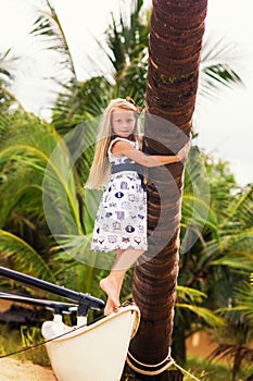 Cute little girl with long hair on the beach