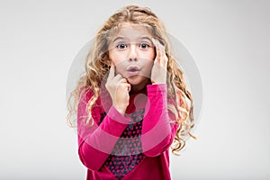 Cute little girl with a look of astonishment photo