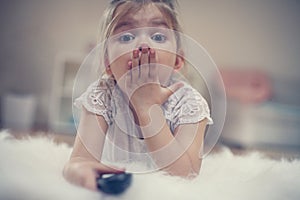 Cute little girl lying on floor.