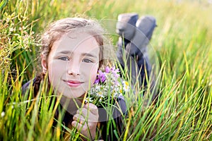 Cute little girl lying on the grass