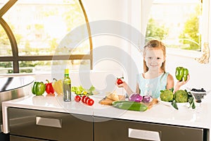 Cute little girl making salad. Child cooking. Healthy food