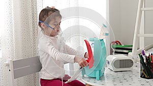 Cute little girl in the mask of an inhaler. Playing with toys. Procedure of inhalation at home. Kid therapy with nebulizer.