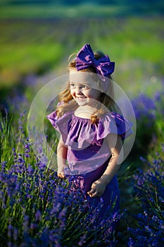 Cute little girl on the meadow in spring day. concept of childhood, health