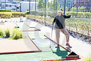 cute little girl on a miniature golf course.