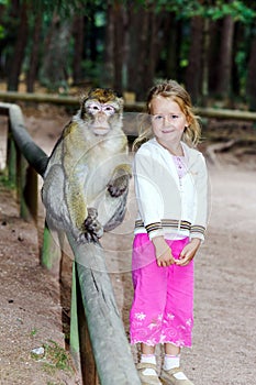 Cute little girl with monkey photo