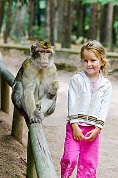 Cute little girl with monkey photo