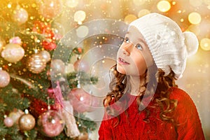 Cute little girl near Christmas tree. New Year card