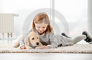 Cute little girl near puppy