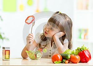 Cute little girl not wanting to eat healthy food