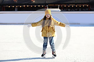 Cute little girl at outdoor ice skating rink