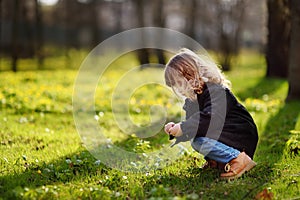 Cute little girl outdoors portrait in spring sunny day