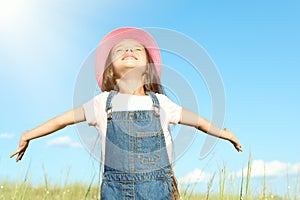 Cute little girl outdoors on sunny day. Child spending time in nature