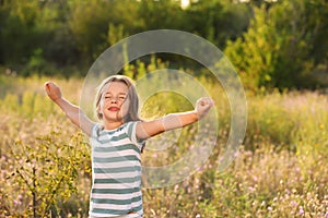 Cute little girl outdoors on sunny day. Child spending time in nature