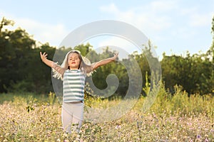 Cute little girl outdoors on sunny day. Child spending time in nature