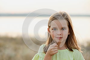 Cute little girl outdoors on sunny day. Child spending time in nature