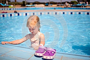 Cute little girl paddling in the kiddies pool