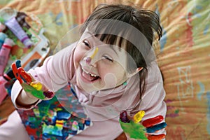 Cute little girl with painted hands