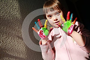 Cute little girl with painted hands