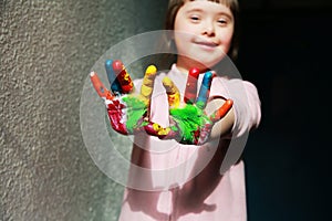 Cute little girl with painted hands