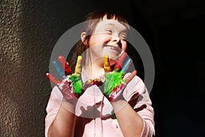 Cute little girl with painted hands