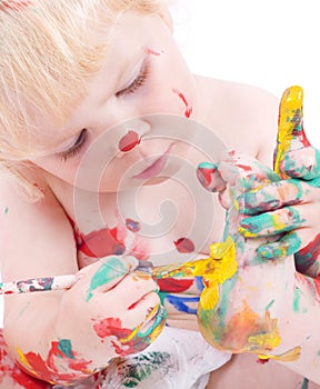 Cute little girl painting her feet