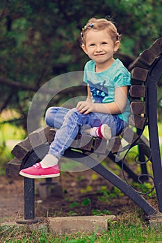 Cute little girl in the park in summer day