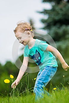 Cute little girl in the park in summer day