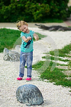 Cute little girl in the park in summer day