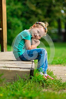 Cute little girl in the park in summer day