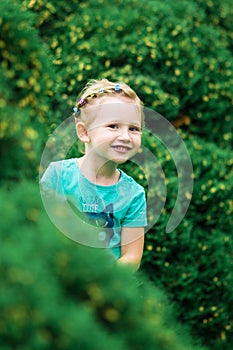 Cute little girl in the park in summer day