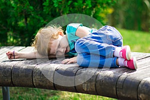 Cute little girl in the park in summer day