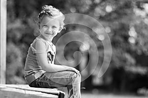 Cute little girl in the park in summer day
