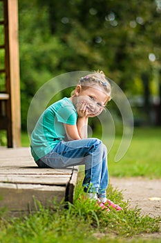 Cute little girl in the park in summer day