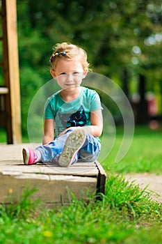 Cute little girl in the park in summer day