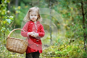 Cute little girl picking mushrooms