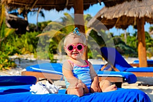 Cute little girl play with seashells on beach